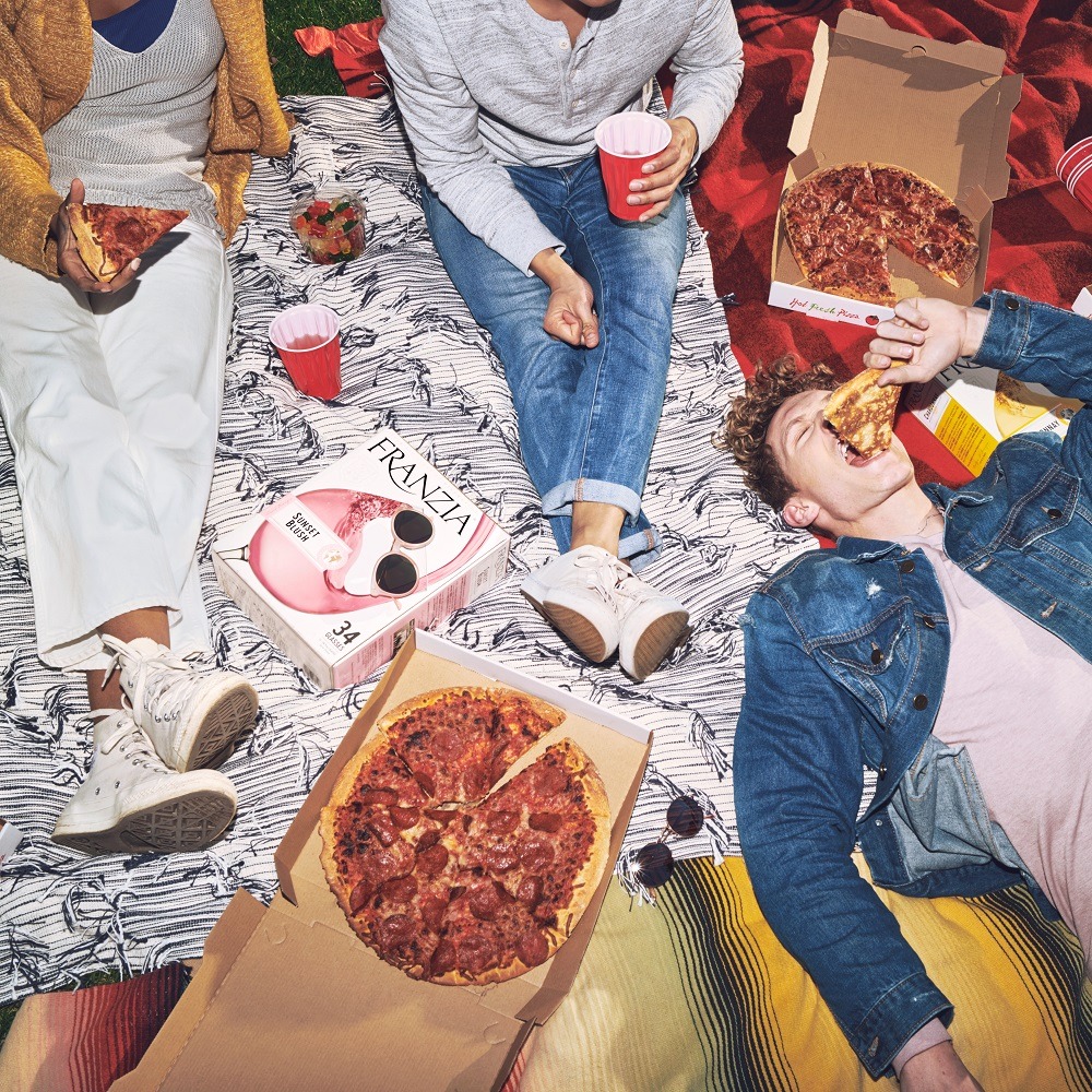 Friends eating pizza and drinking Franzia wines