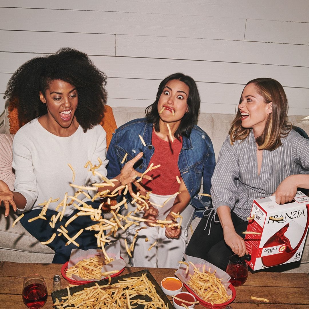 Friends pairing Franzia wine with food (french fries)