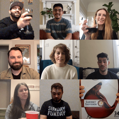 Friends cheersing during a virtual meeting with a box of Franzia