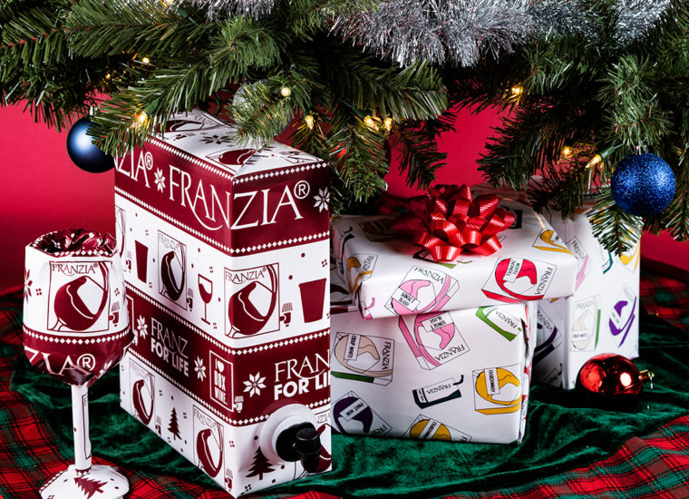 Franzia holiday wrapping paper under a Christmas tree